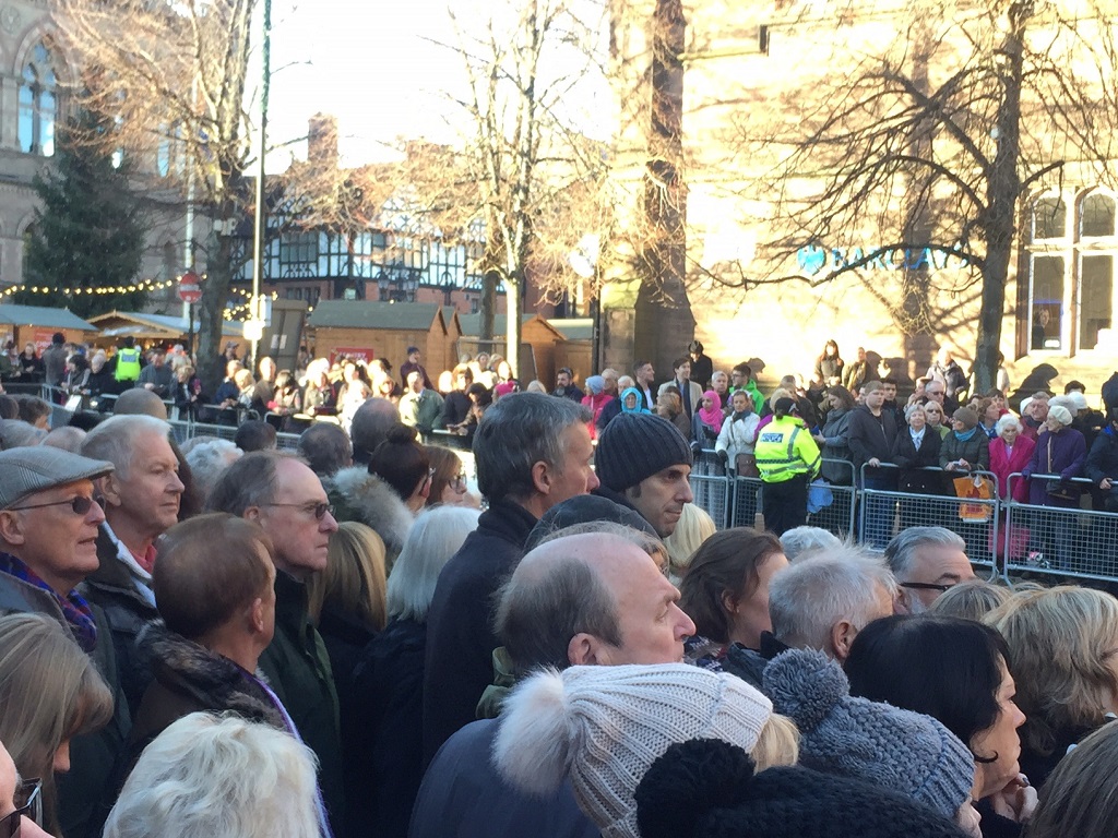 Crowds line the street to see the arrival of the Royal family