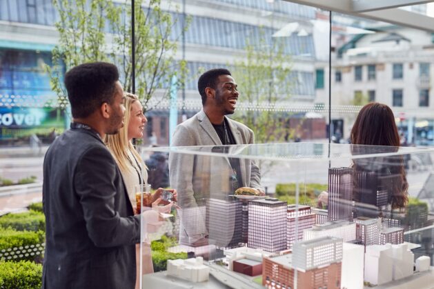 Guests Looking At A Model Of The £750m Circle Square Development