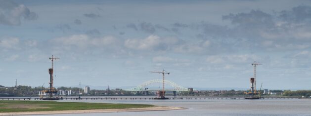 Mersey Gateway View Of Tower Cranes And Pylons In Mersey Estuary With Silver Jubilee Bridge In The Background Credit David Hunter