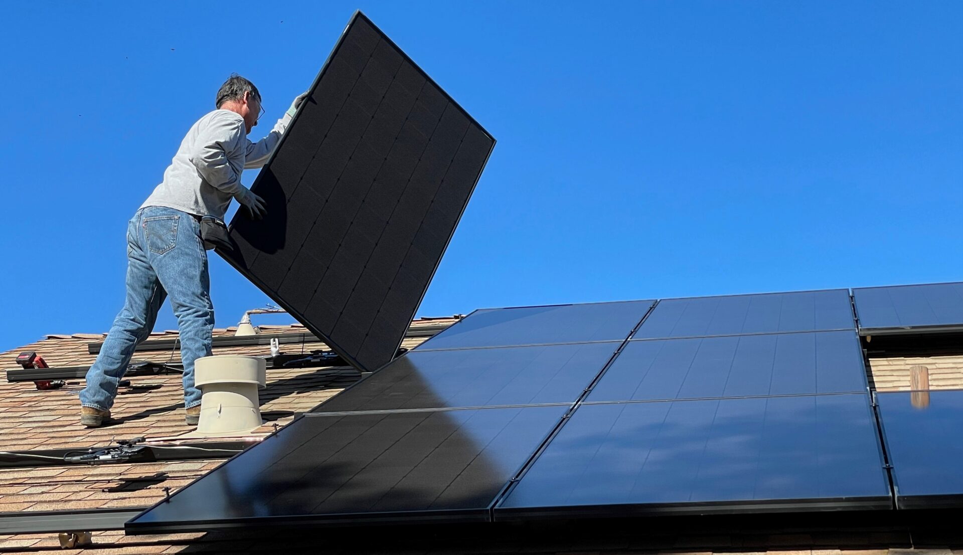 Solar panels being fitted to a roof