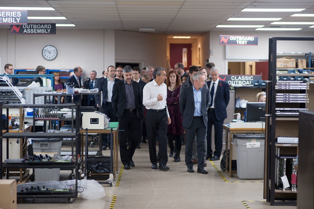 Mark Crabtree of AMS Neve in white shirt leads group on factory tour